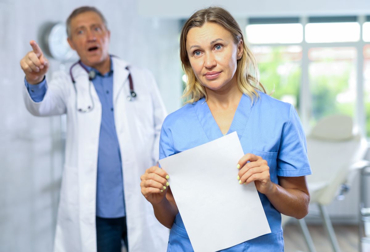 A nurse and doctor try to de-escalate a tense moment with a patient.