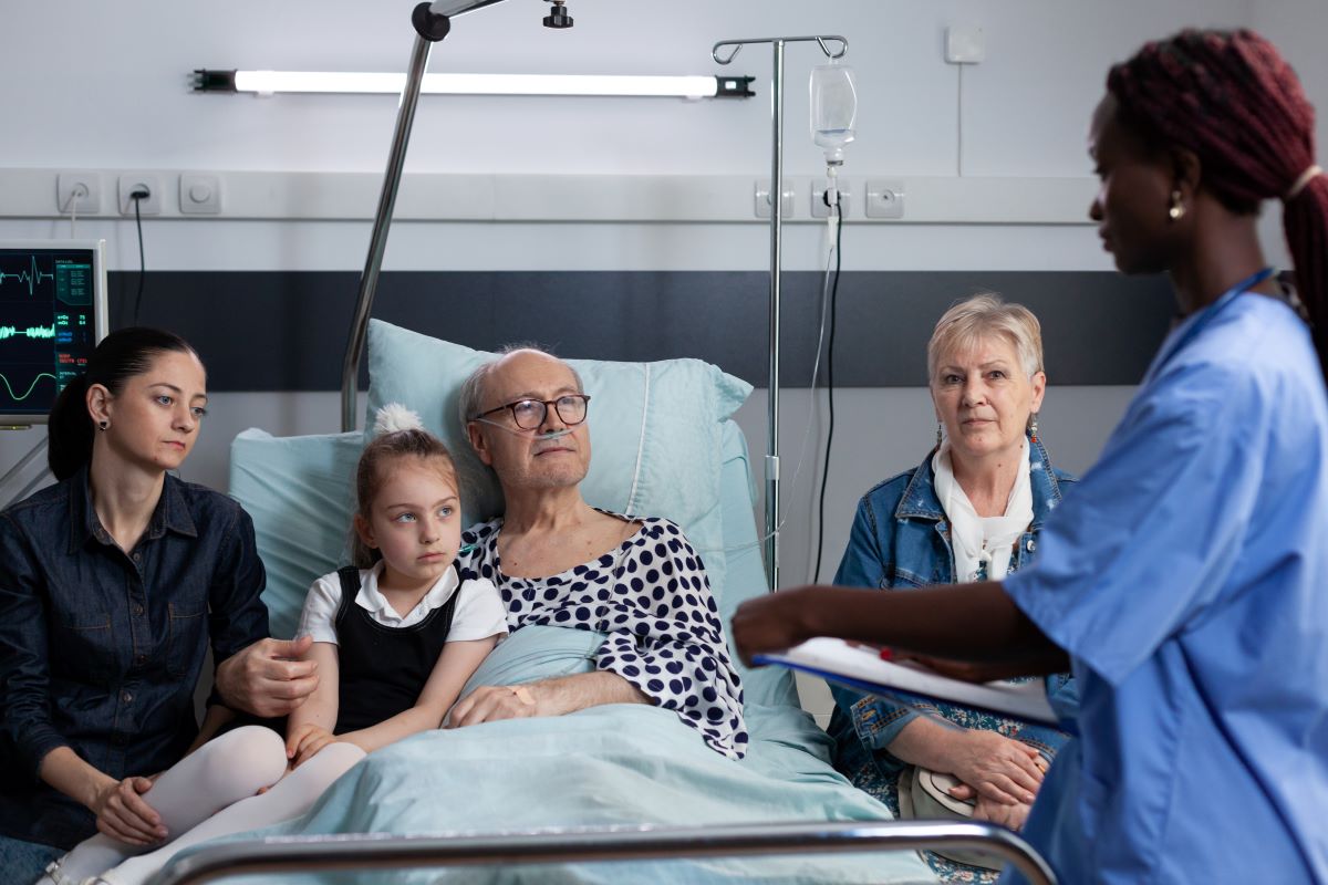 A patient is being admitted, while a nurse writes up a nursing admission note.