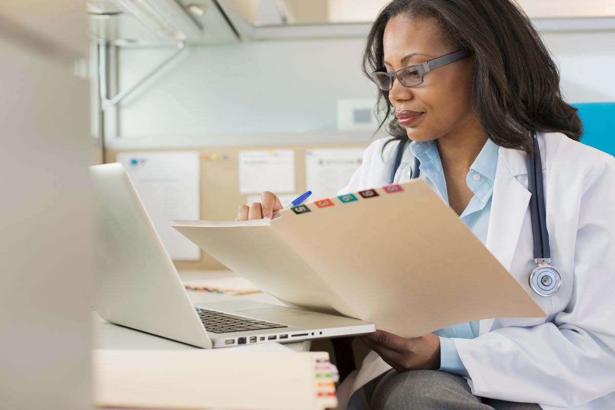 A healthcare professional looking at medical files.