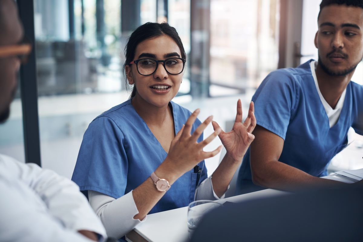 Nurses meeting at a table.