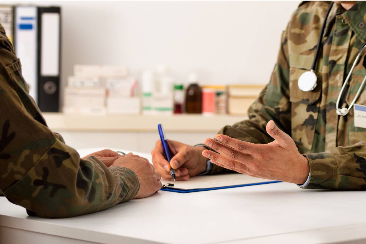 An army nurse talks to a patient.