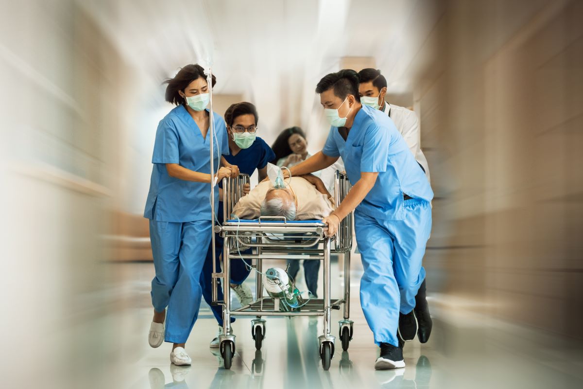 Trauma nurses hurry a patient to the OR.