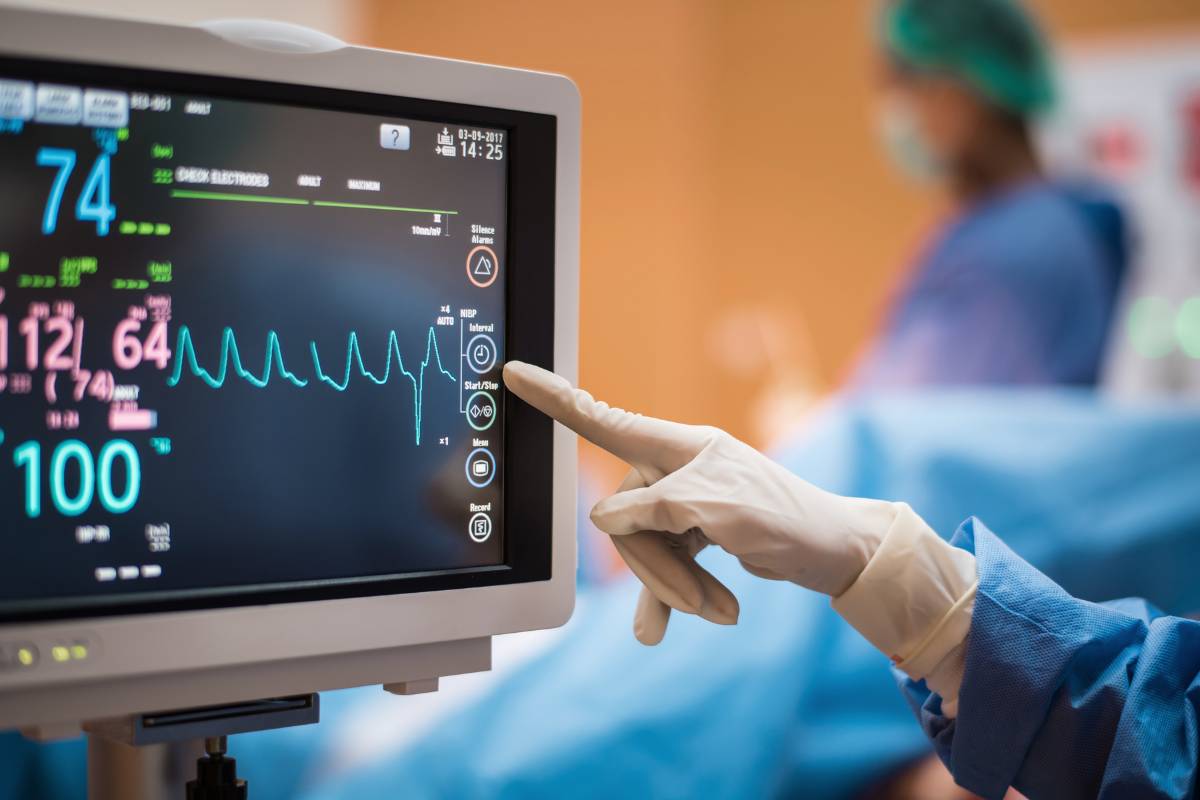 A nurse puts their telemetry nurse resume skills to use while reading a monitor.