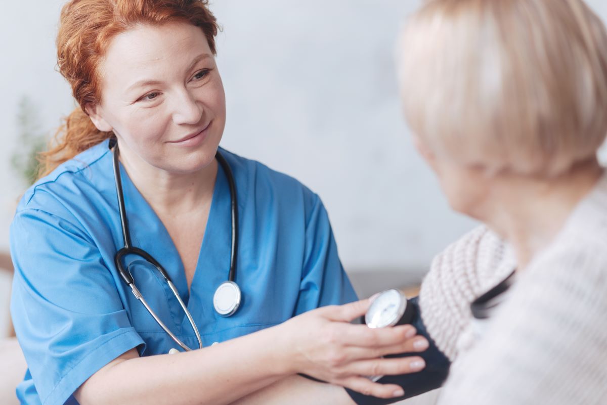 Urgent care nurse taking blood pressure of patient