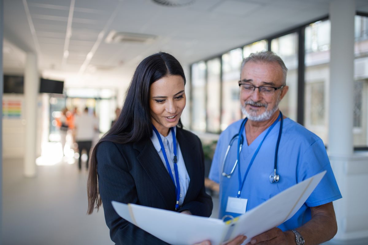 A healthcare MSO representative meets with a physician.