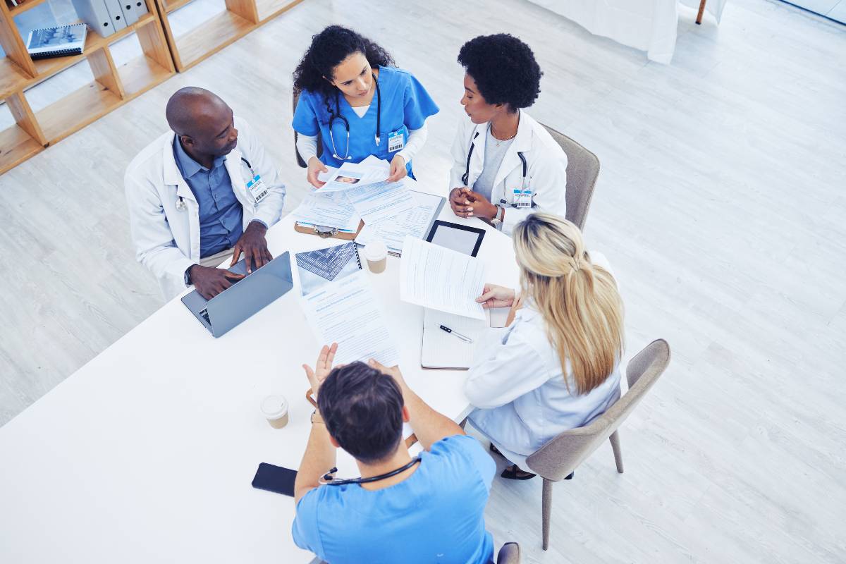 A health policy nurse meets with a team of healthcare professionals to discuss changes.