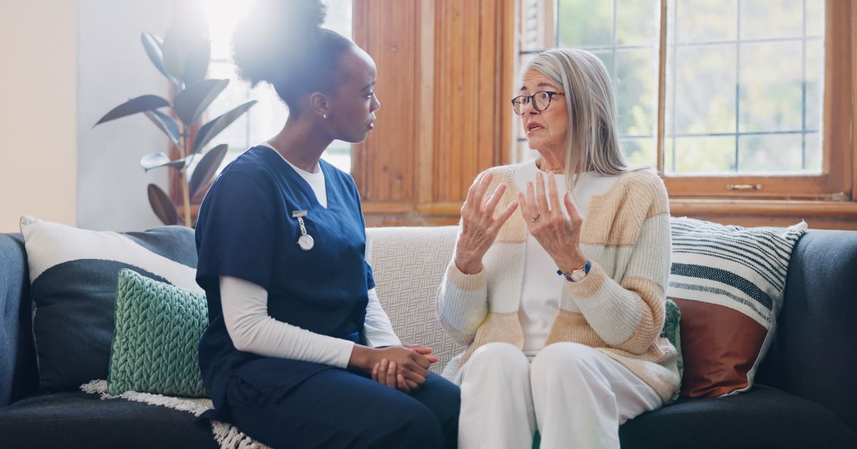 A nurse listens to one of her patients explain an event.