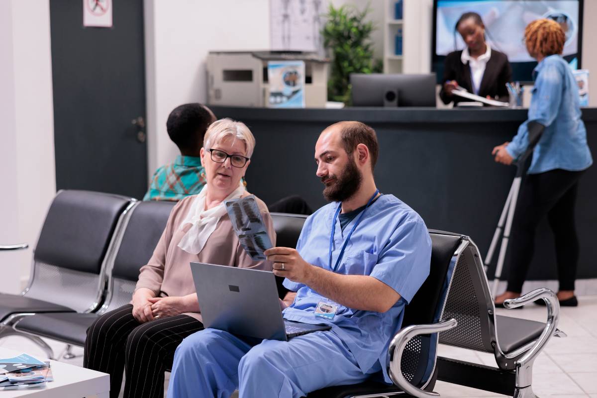 A medical interpreter helps a patient understand their X-ray results.