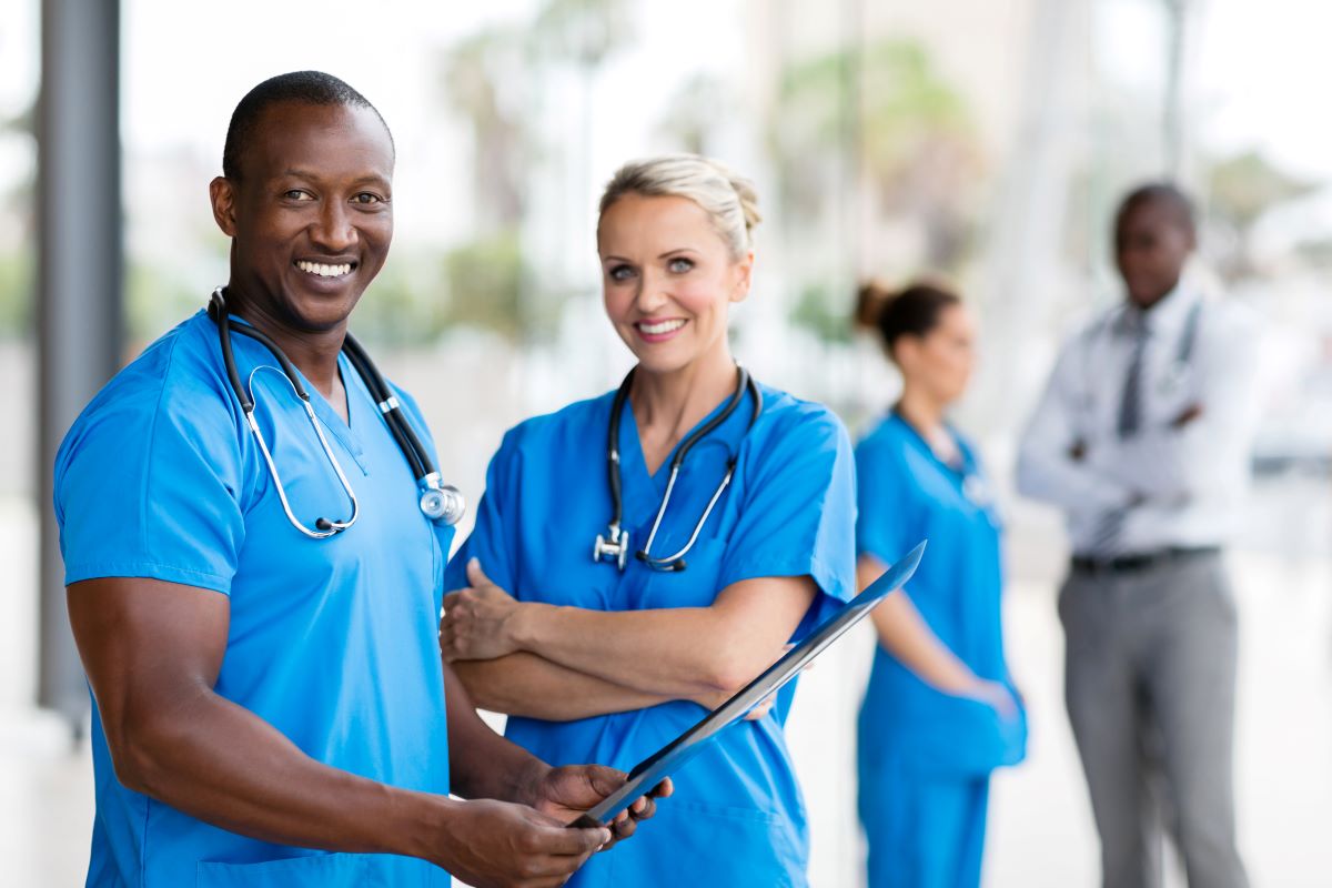 Two nurses take a break outside of their facility.