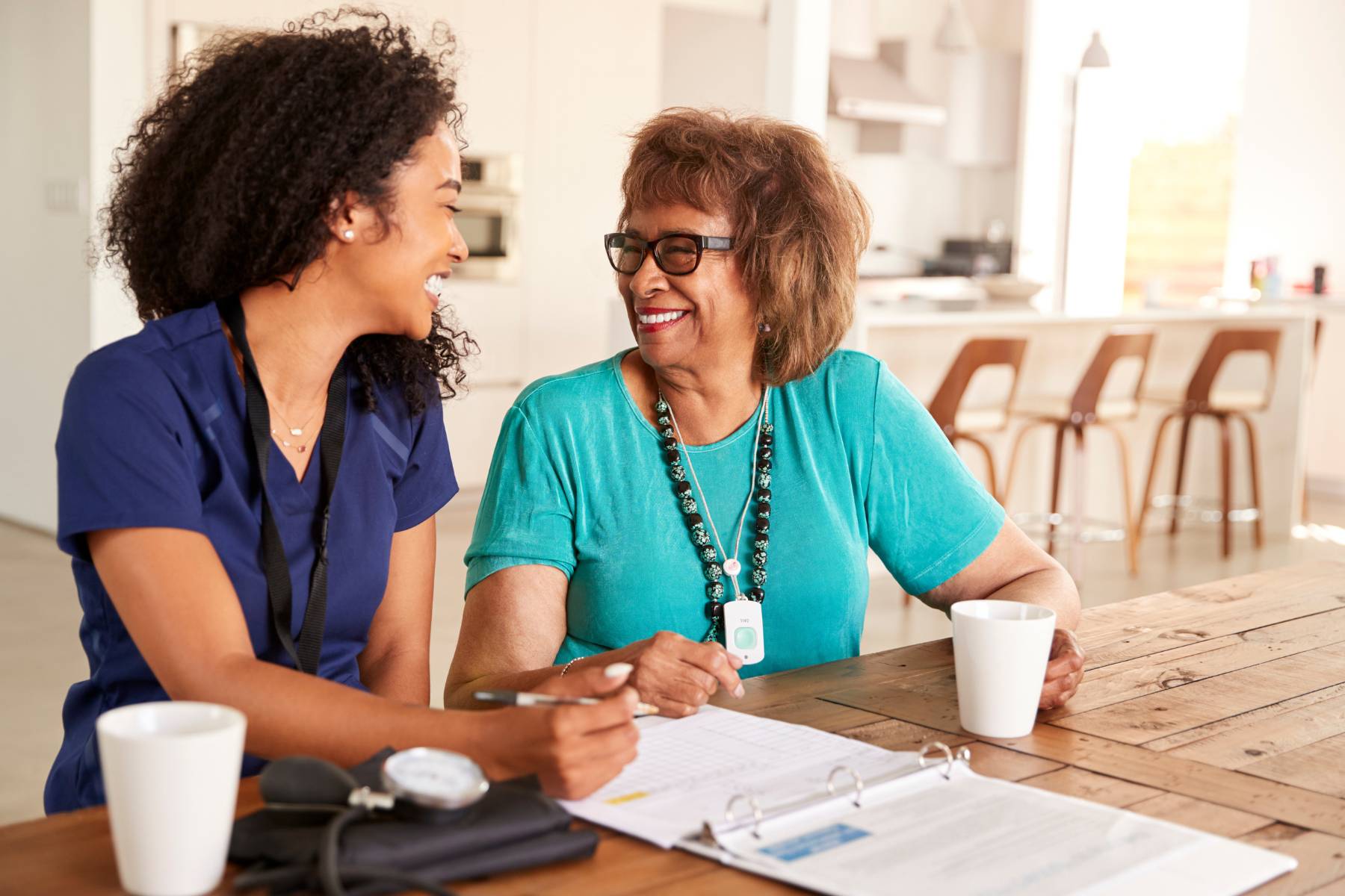 A concierge nurse assists a client with filling out medical paperwork.