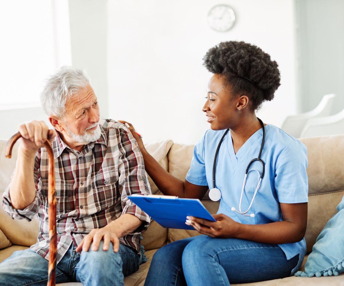 A nurse meets with a resident of the LTC facility where she works.