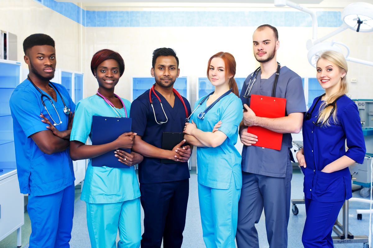 A group of six nurses poses for the camera.