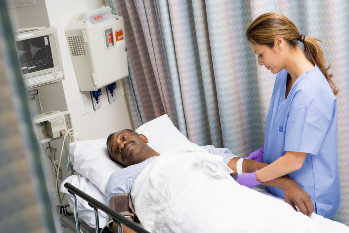 A pre-op nurse prepares a patient for surgery.