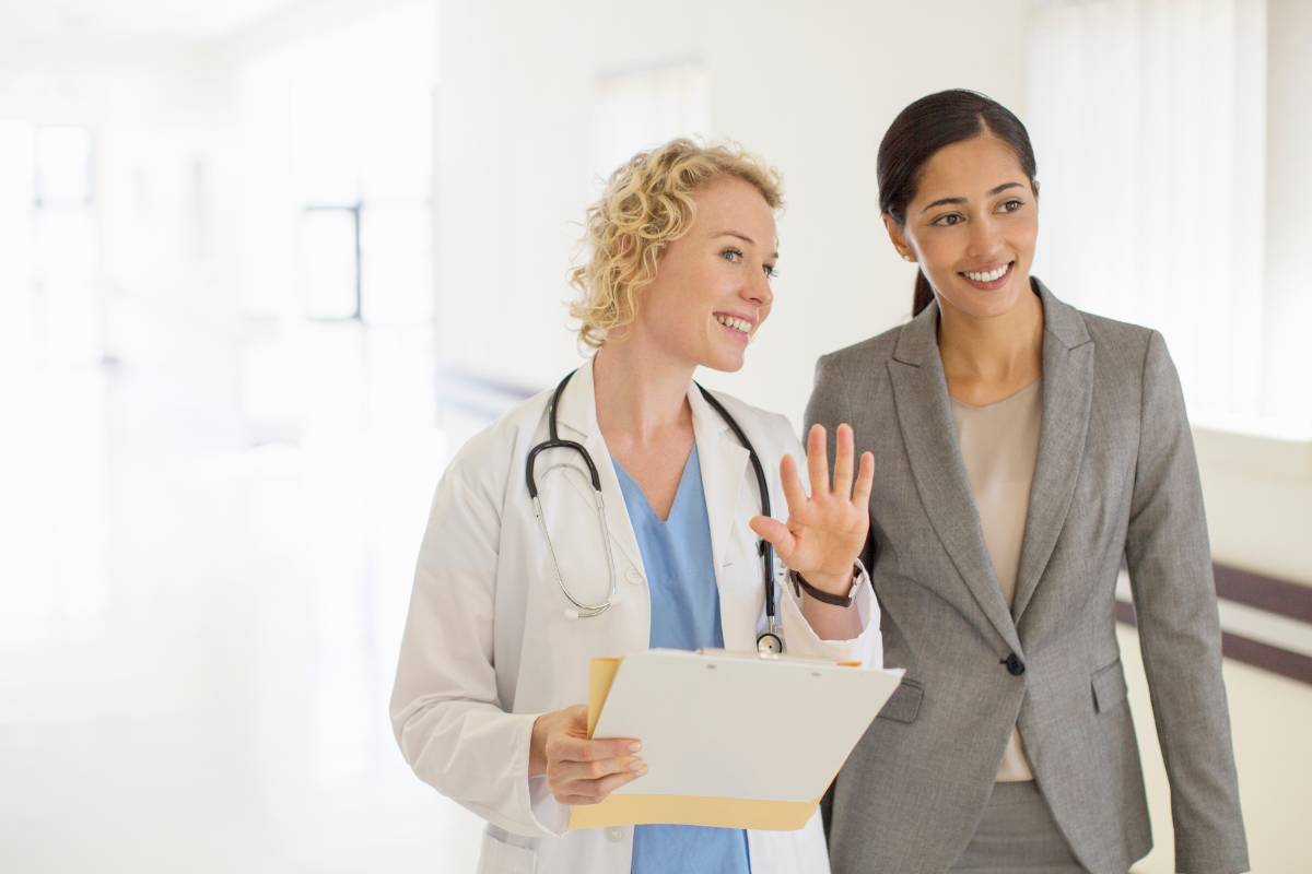 A nurse demonstrates what to do with an MBA in nursing while talking to a colleague.