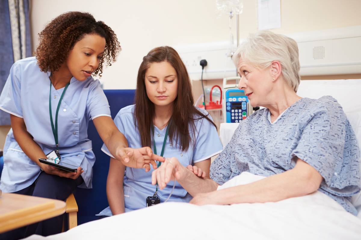 A nurse works with her mentor in a nurse residency program at her workplace.