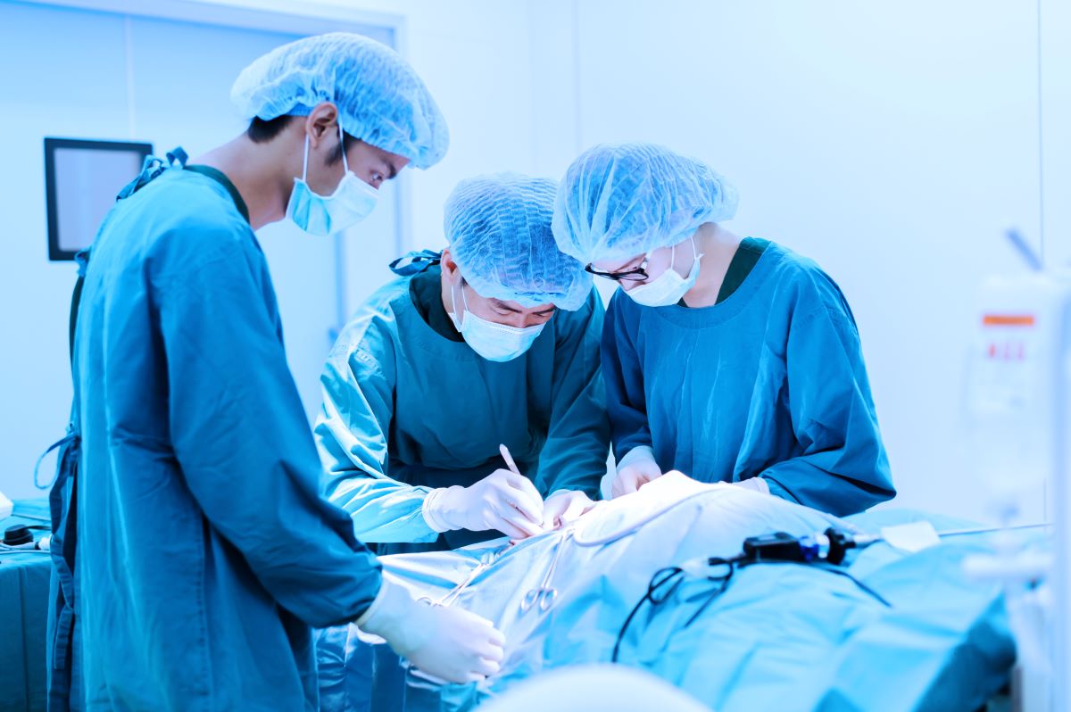 A surgical tech assists physicians during surgery.