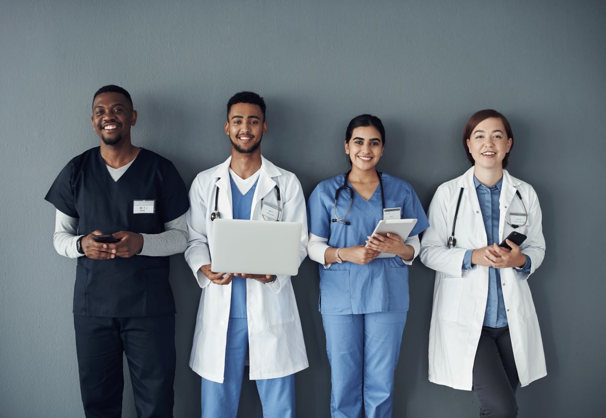 A group of nurses and physicians prepares to ask a candidate peer interview questions.