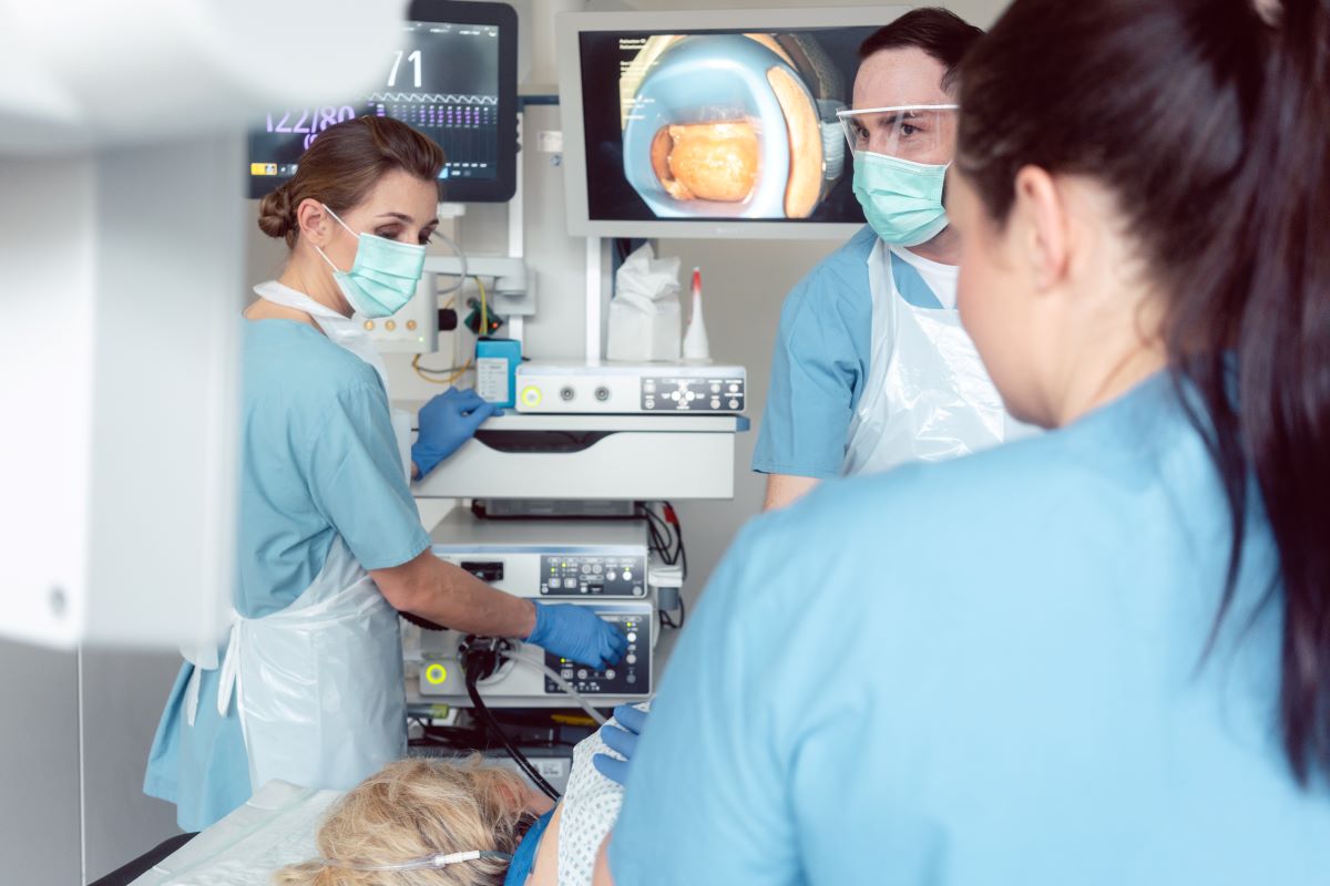 Endoscopy nurses assist with a procedure.