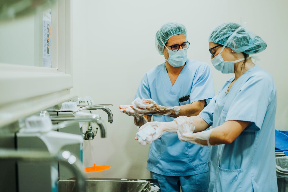 An infection control nurse consults with a surgical nurse prior to a procedure.