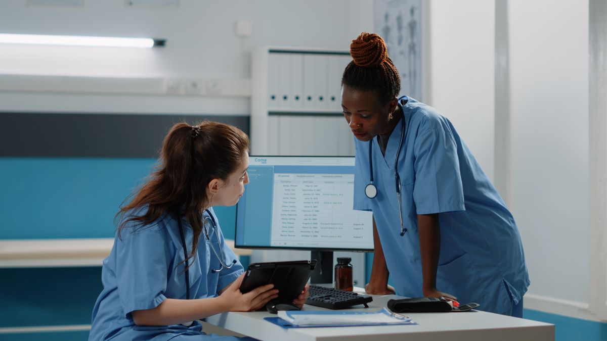 Arkansas nurses discuss a patient's chart.