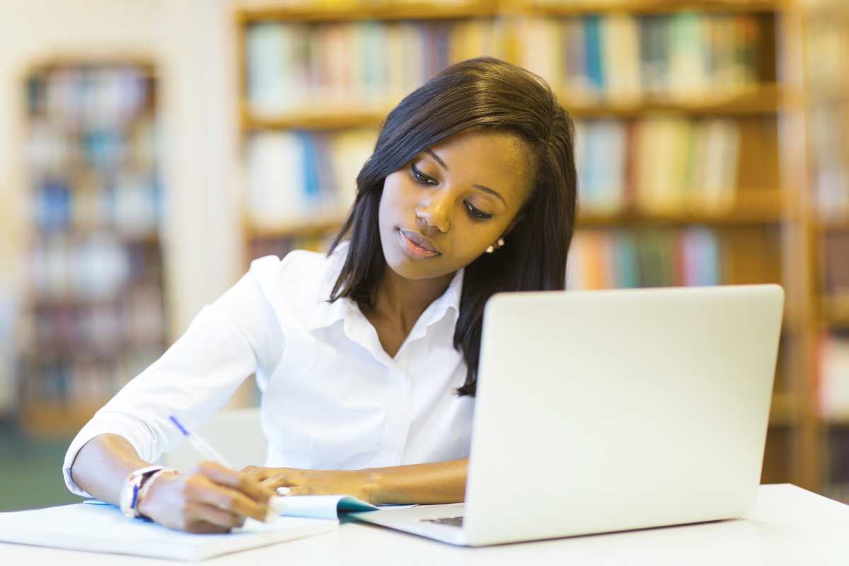 Female student studying for HESI or TEAS exam for nursing school.