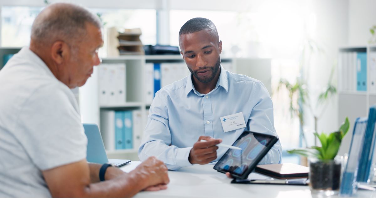 A hospital case manager meets with staff.