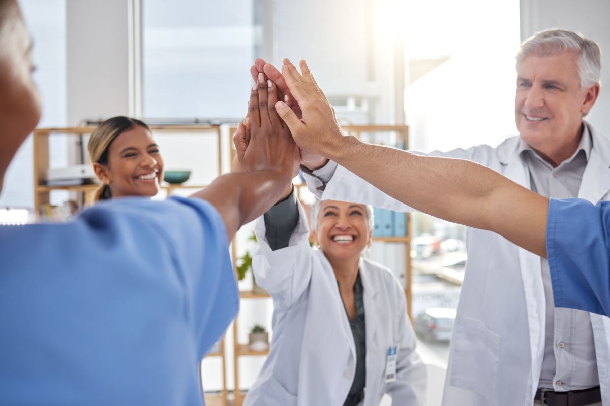 A team of physicians and nurses thank each other for a job well done.