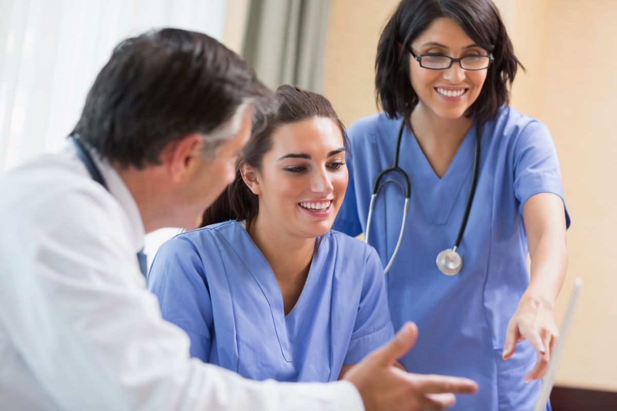 Nurses talk with a physician.