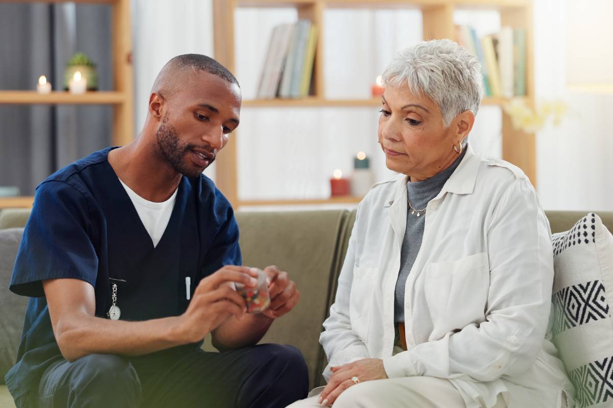 A healthcare professional with nurse coach certification educates a patient about their medication.