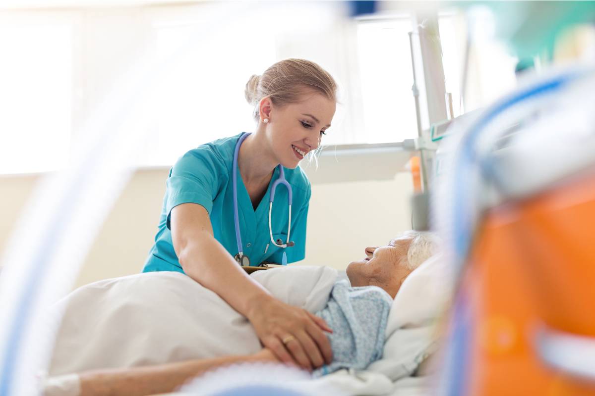 A nursing assistant uses her hospice aide certification skills while assisting a patient.