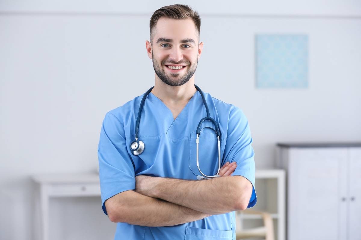 A medical assistant with NCMA certification poses for a picture in a hospital room.