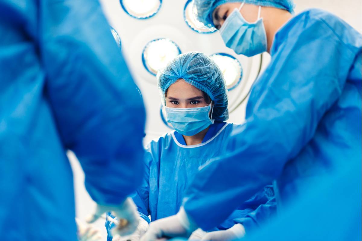 An anesthesia technician assists with a medical procedure.