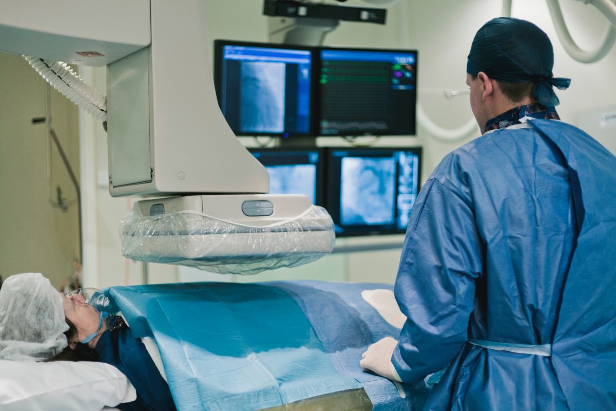 A cath lab nurse checks on a patient prior to surgery.