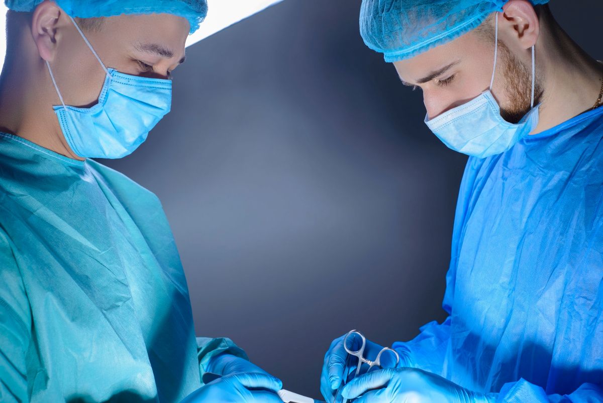 A cath lab nurse works closely with a physician during a procecure.