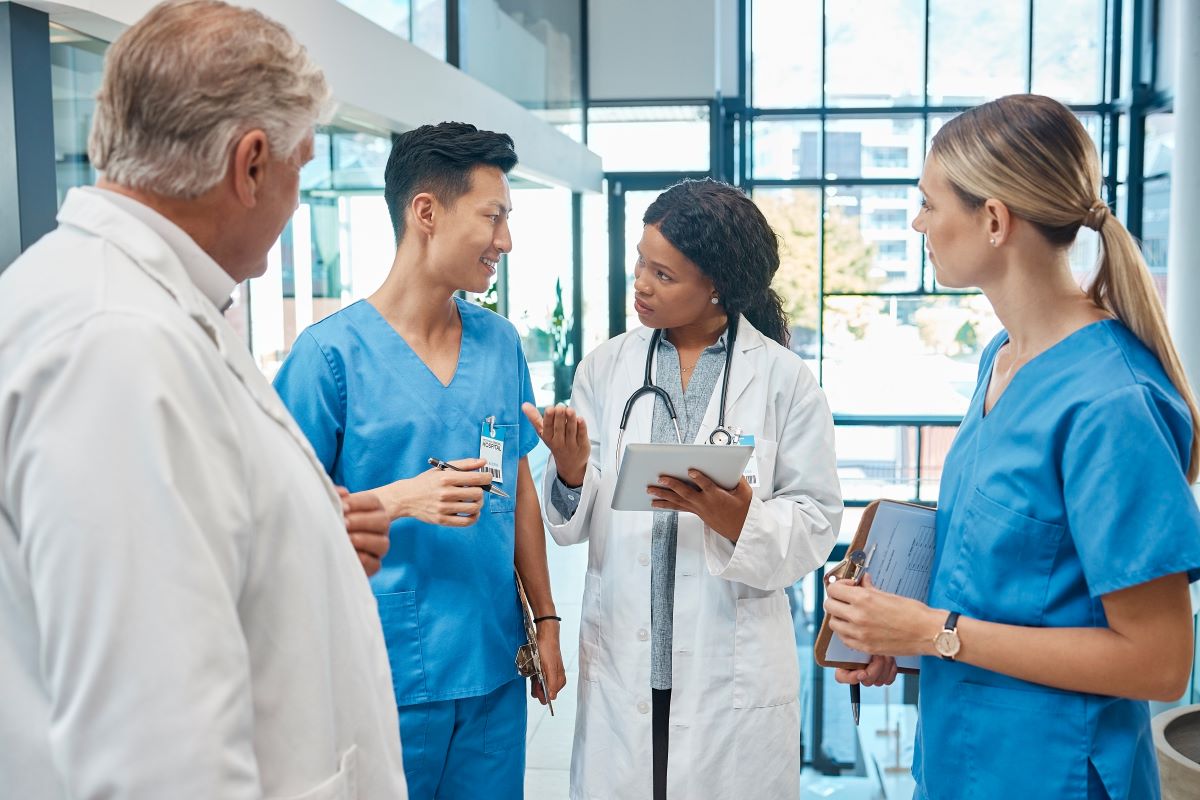 A clinical nurse leader talks with her staff.