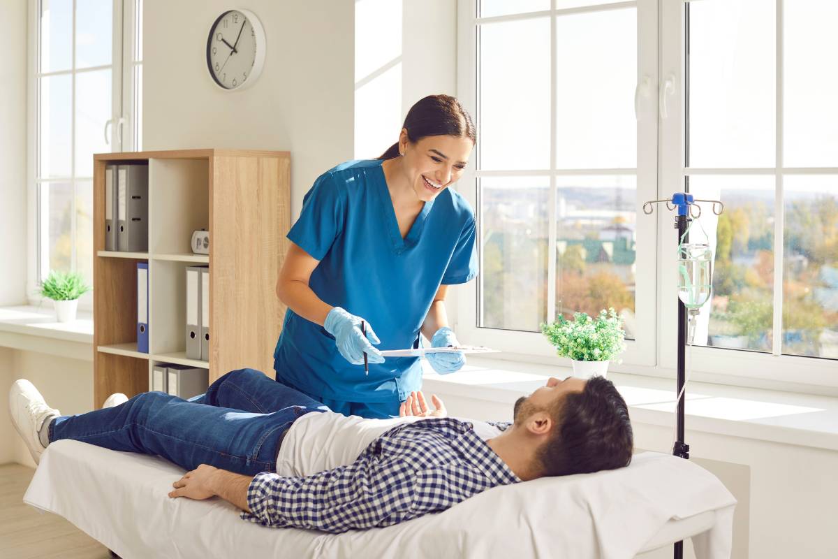 An infusion nurse with CRNI certification assists a patient at a dialysis clinic.