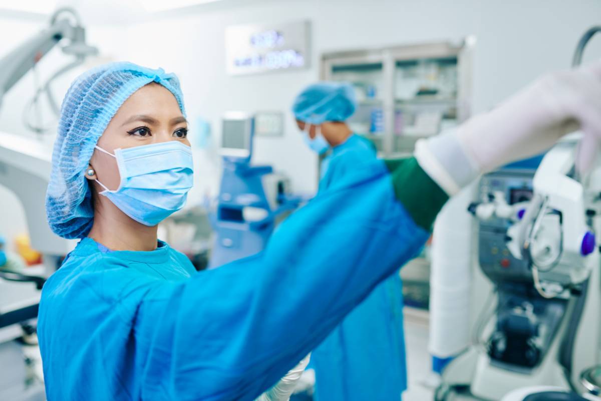 A CVOR tech assists during a cardiac operating room procedure.