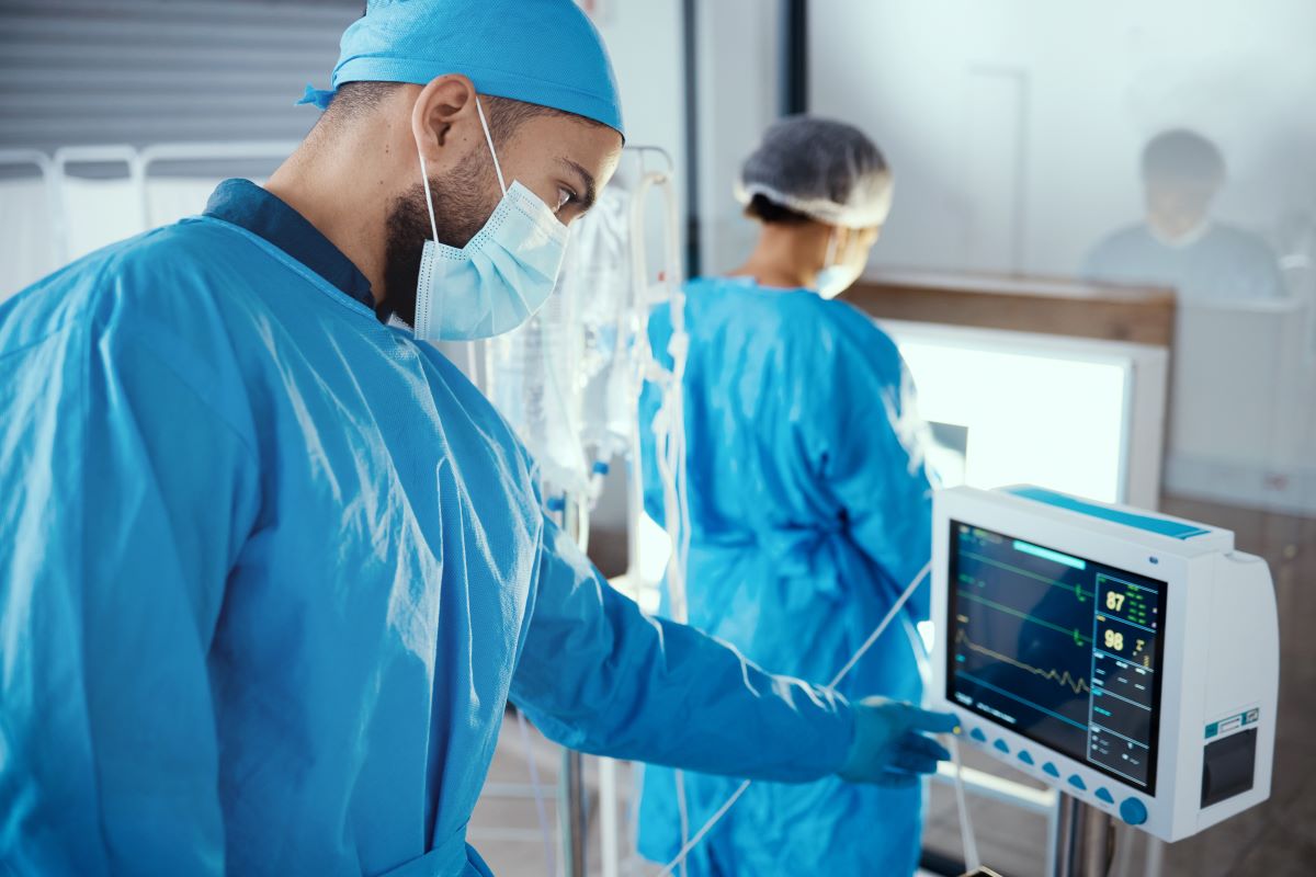 A nurse checks the monitor of a kidney dialysis machine.