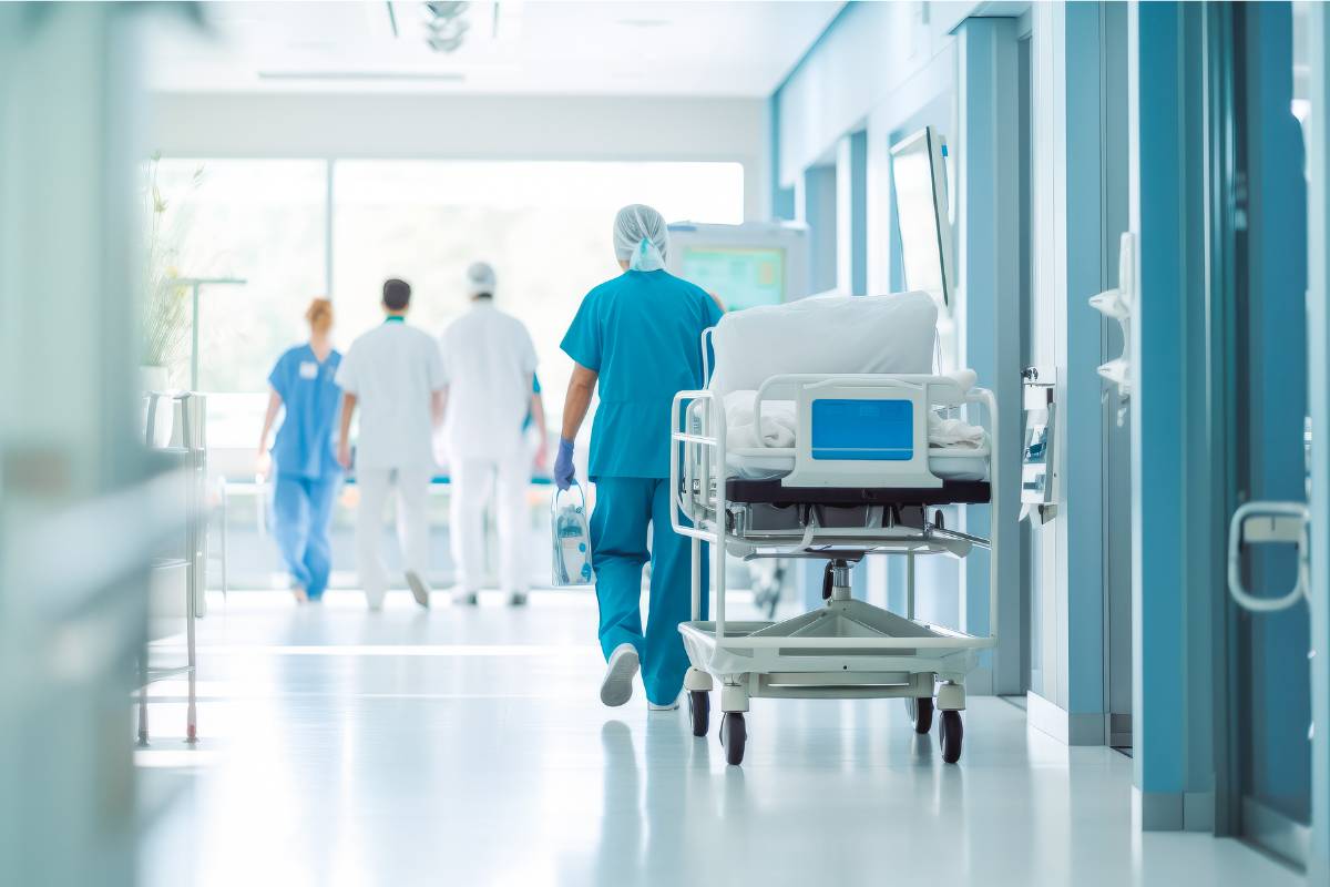 A nurse pushes a gurney in one of the hospital units at a healthcare facility.