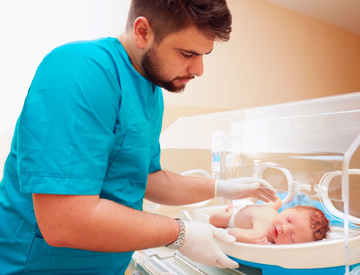 A neonatal nurse checks on one of the infants he's looking after.