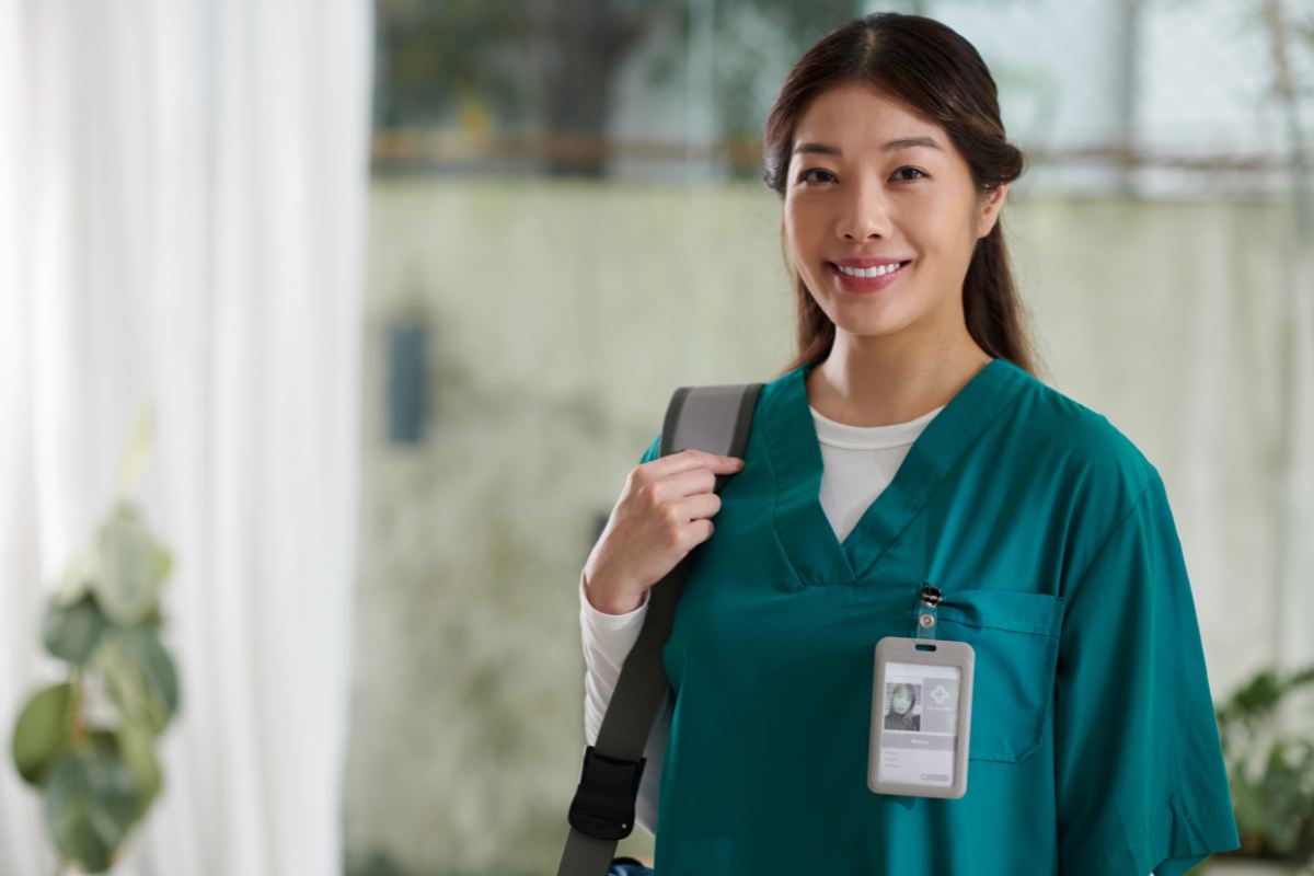 A nurse wears her nurse badge reel before work.