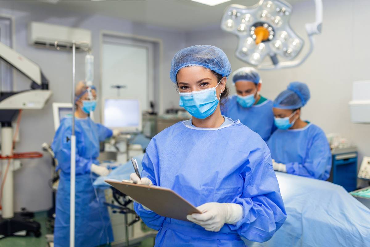 A pre-op nurse reviews a pre-procedure checklist before surgery.