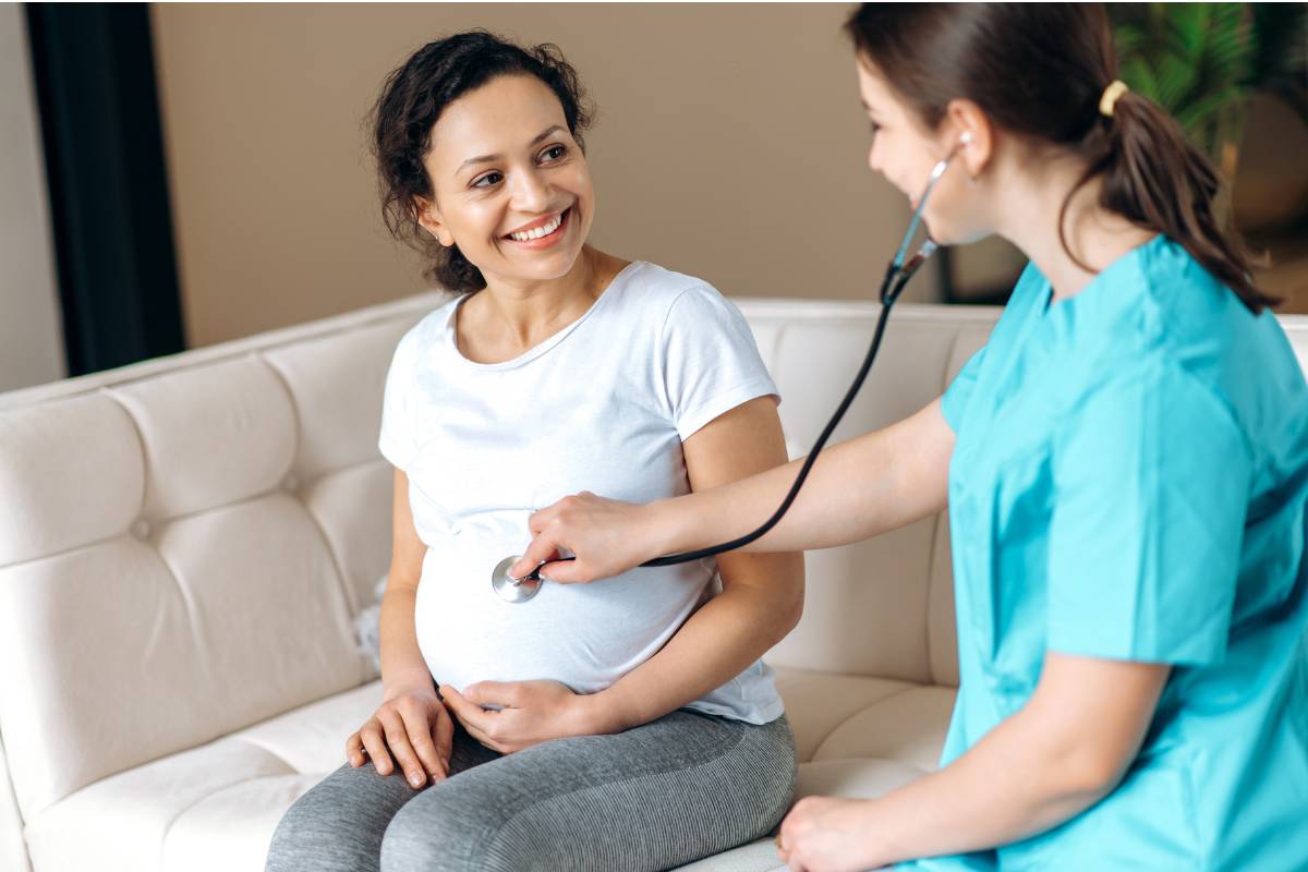 A nurse with RNC-OB certification assesses a pregnant patient.