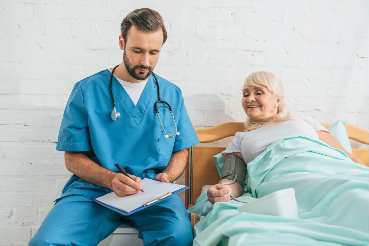 A nurse practitioner with AGACNP-BC credential speaks with a patient.