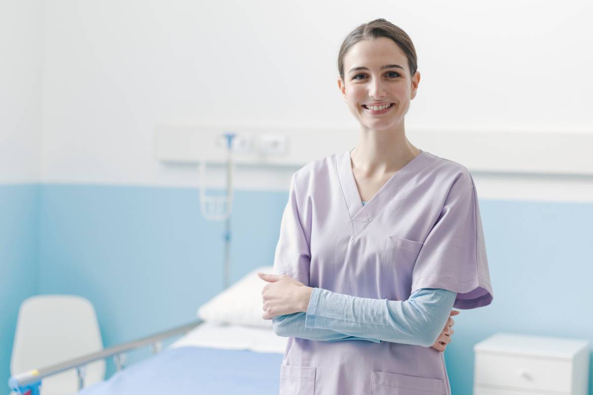 A nurse with CVRN certification stands in a hospital room.