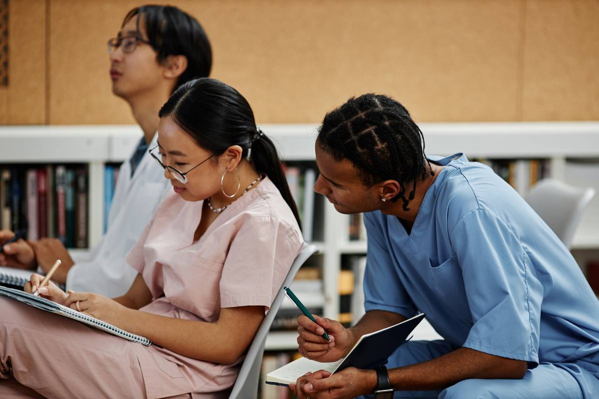 Two nursing students study Faye Abdellah nursing theory in class.