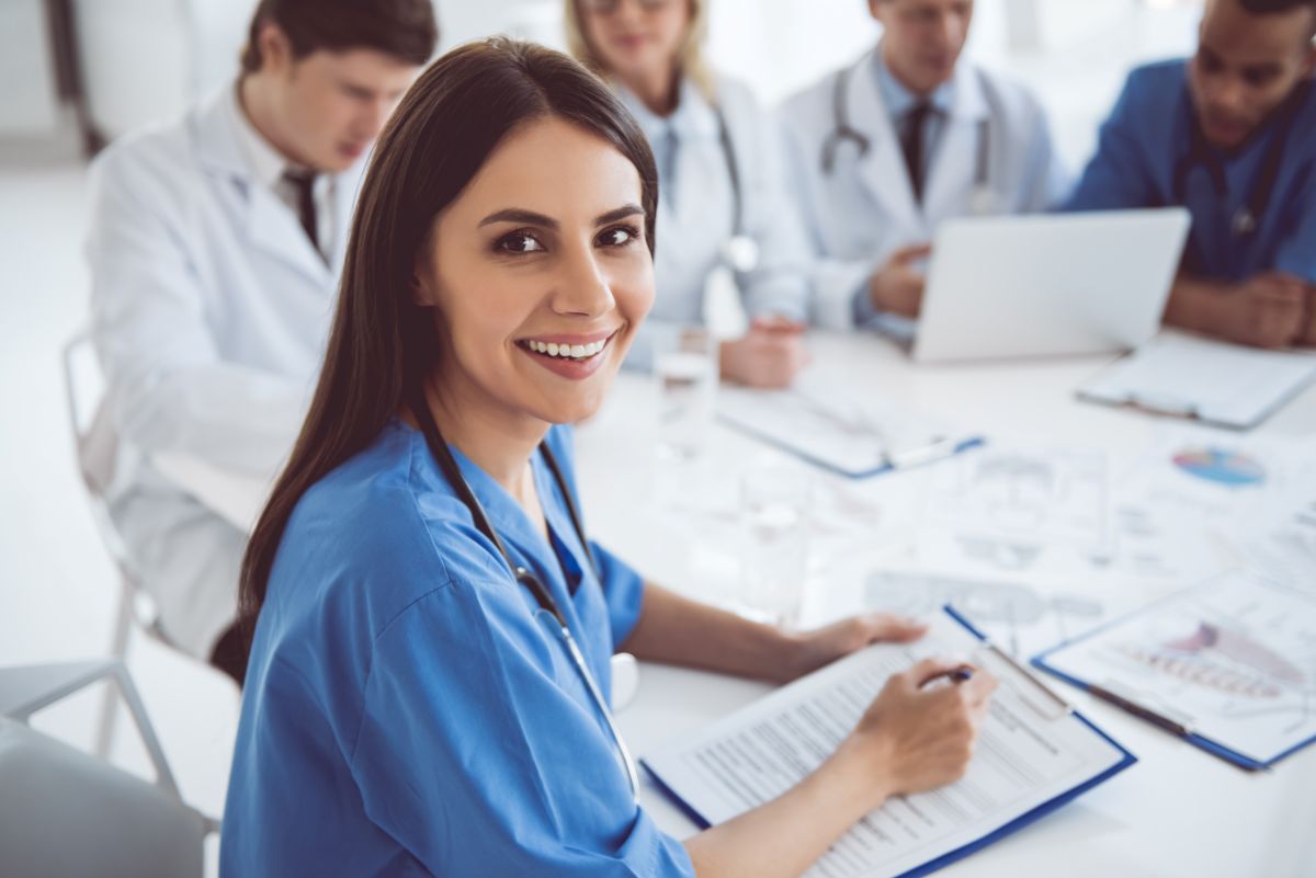 Young nurse smiling at camera in a medical office