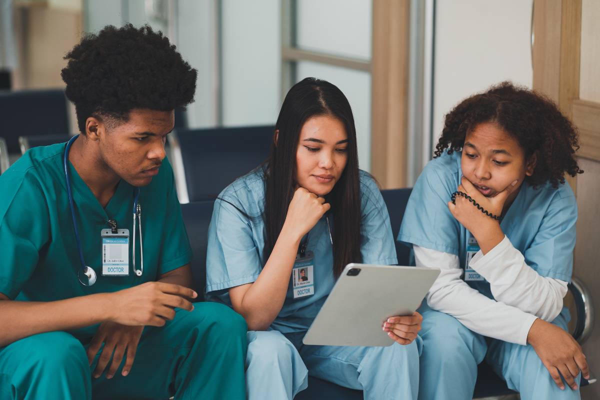 A group of nursing students studying the Imogene King nursing theory before a test.