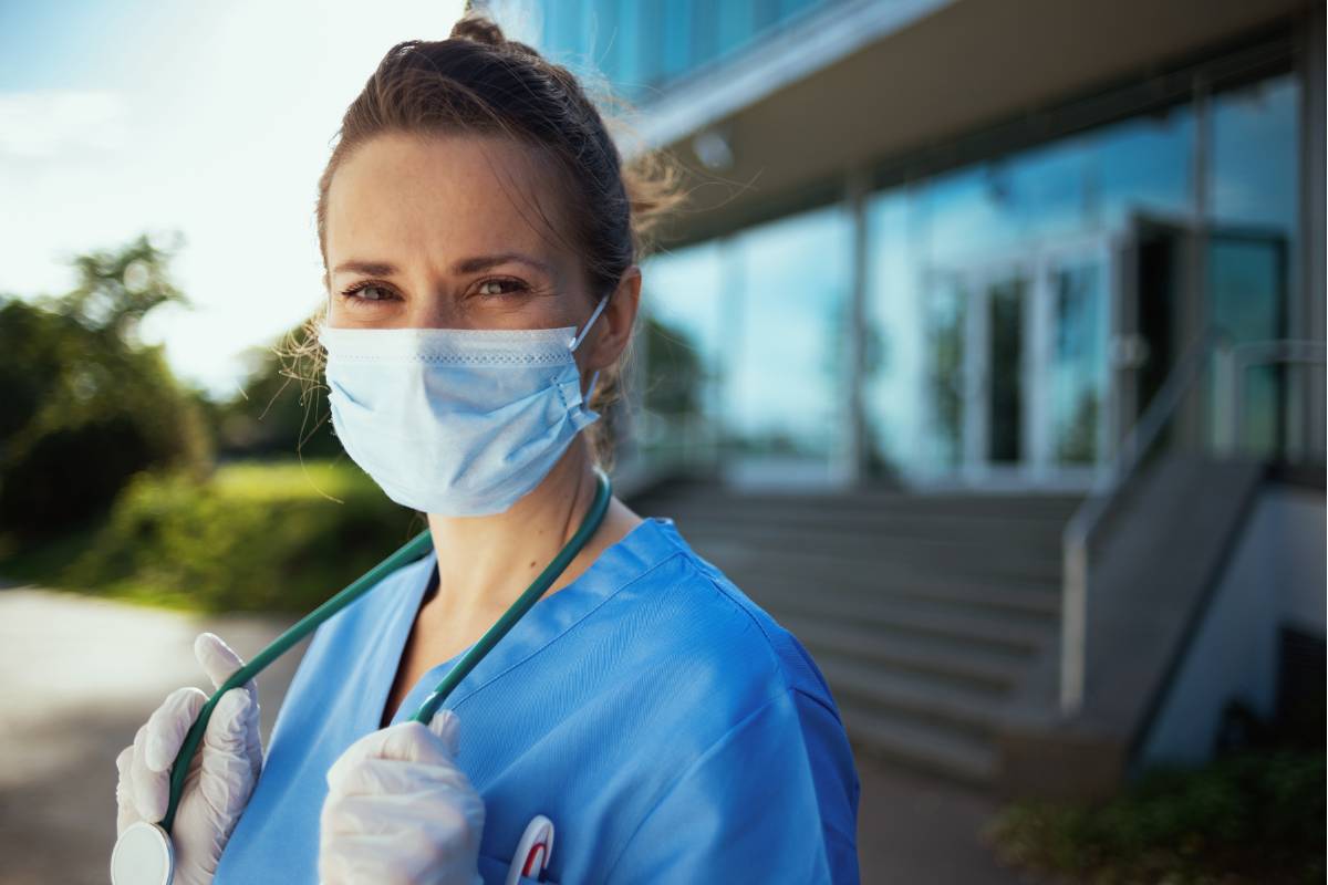 A nurse stands outside and prepares for an international nursing assignment.