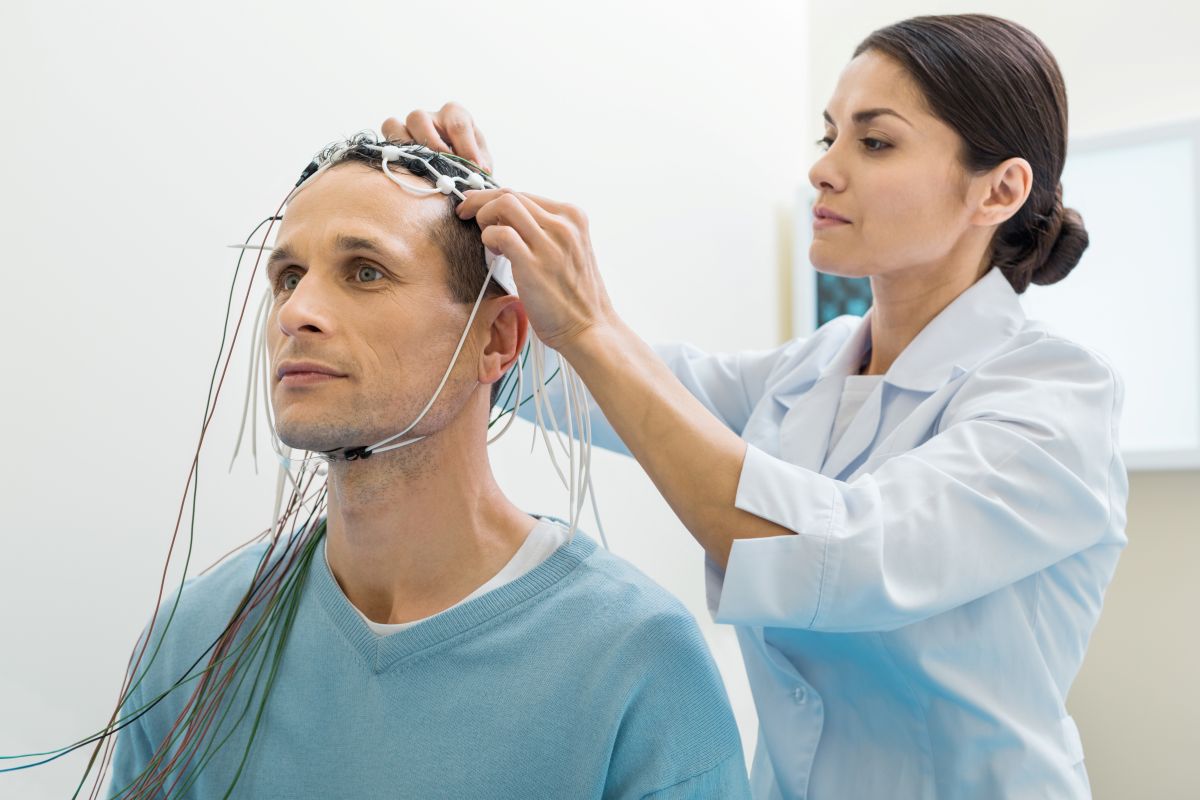 A neuro nurse prepares a patient for a brain imaging procedure.